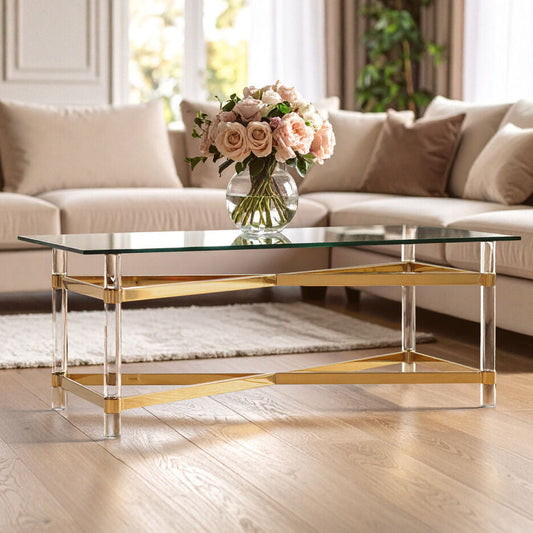 Glass coffee table with gold base in a living room setting