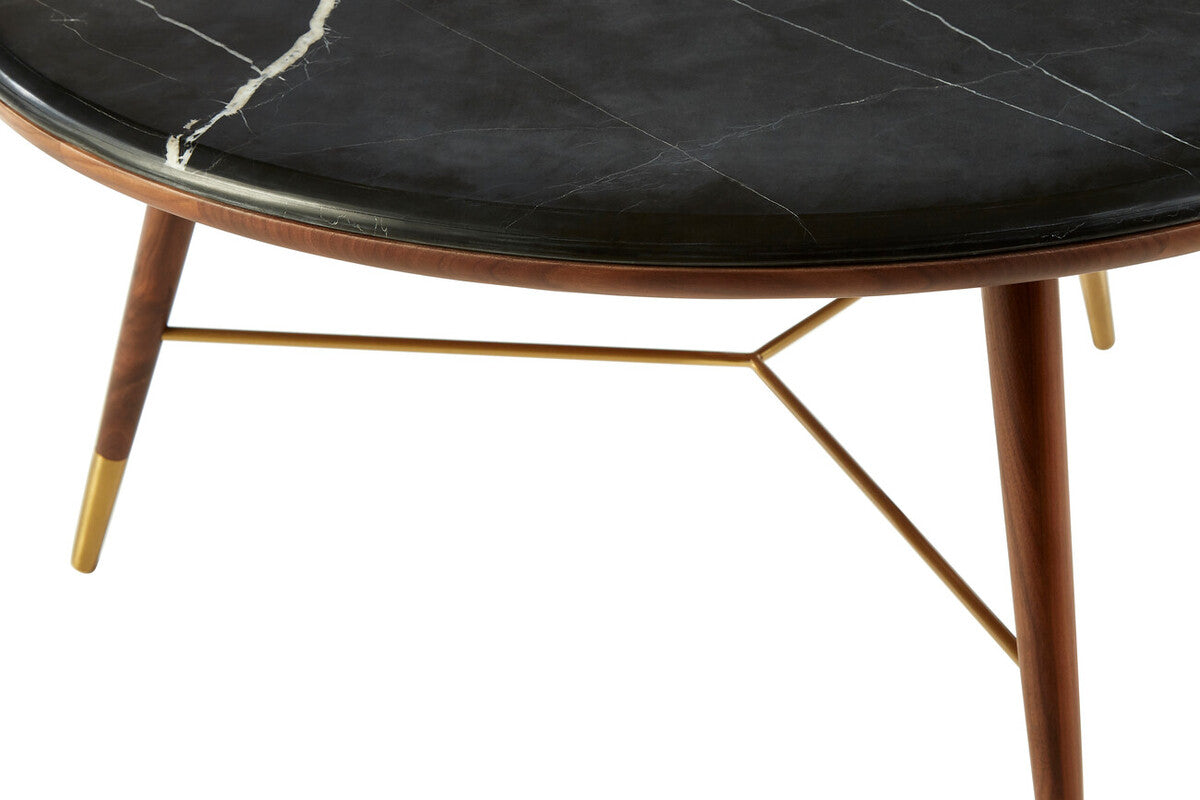 Round coffee table with black marble top and wooden legs on a white background