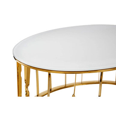 Round table with gold metal legs and white marble top on a white background