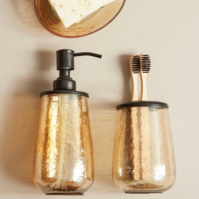 Allegra Black and Gold Textured Glass Soap Dispenser styled on a vanity