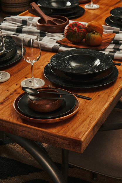 Wooden serving plate styled with bread and nibbles