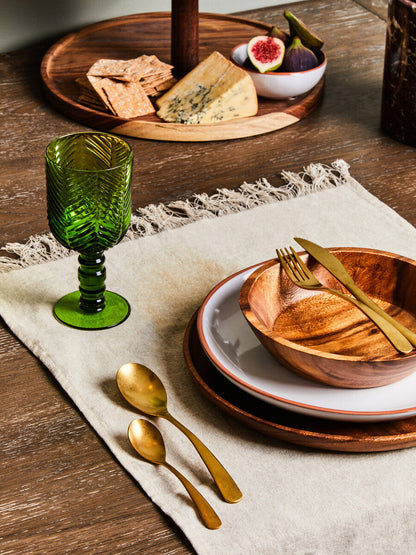 Acacia wood serving plate styled on a dining table