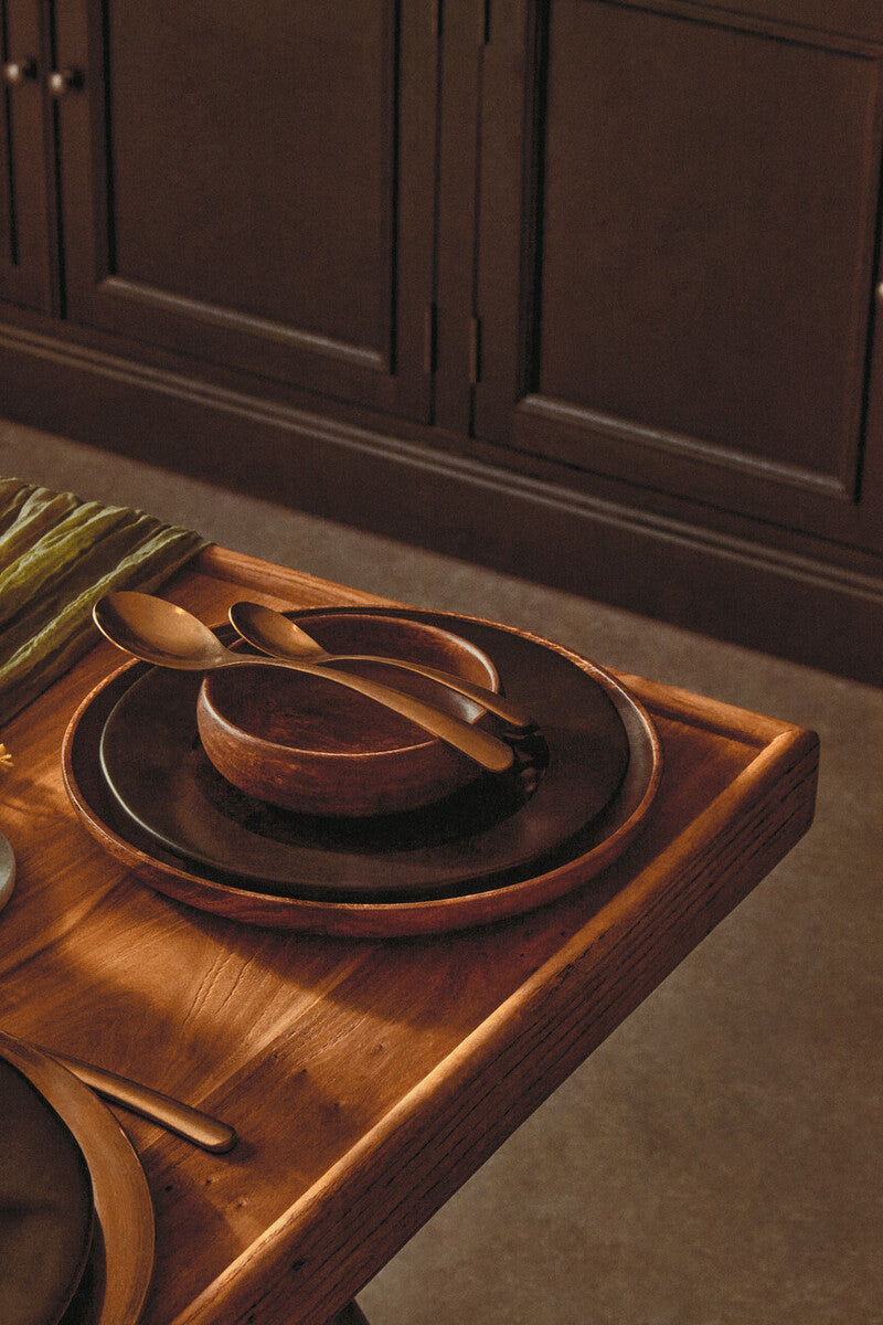 Acacia wood serving plate styled for a dinner party