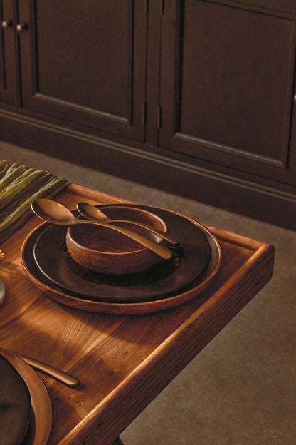 Acacia wood serving plate styled for a dinner party