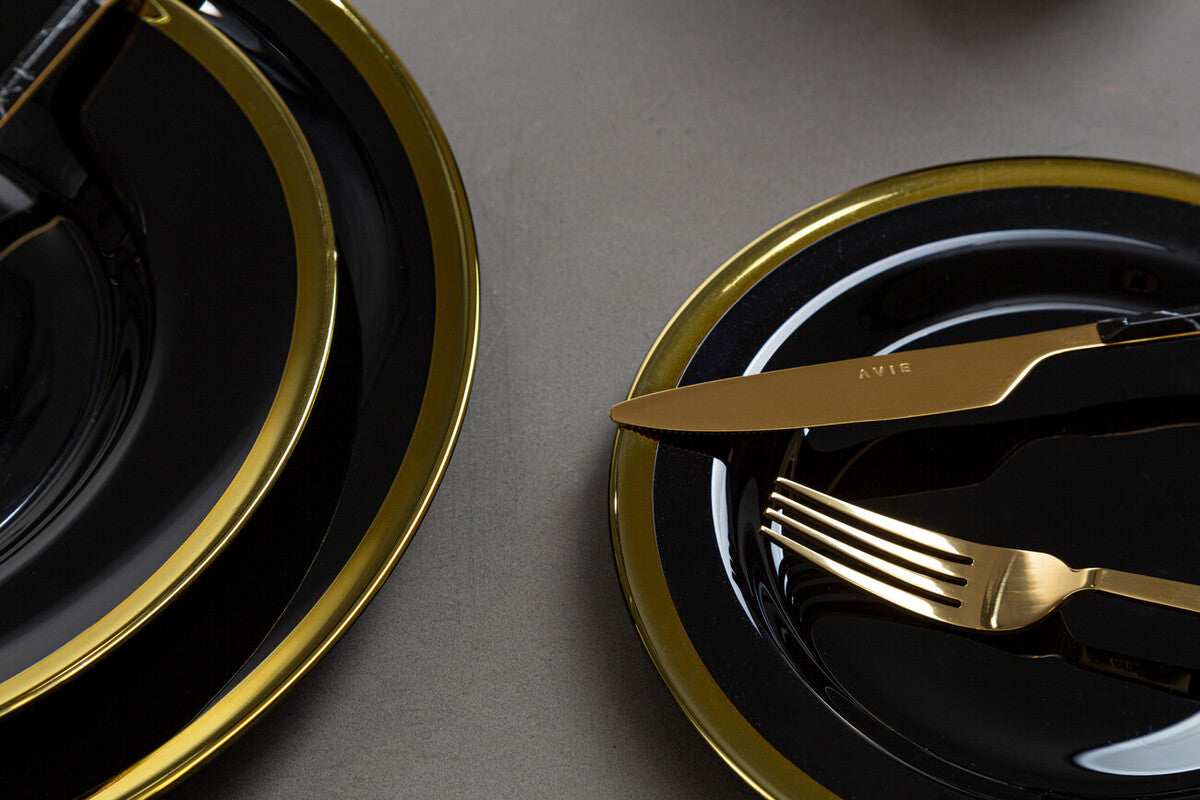 Close-up detail of the gold rim on a black glass charger plate