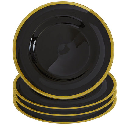 Black glass charger plates styled with glassware and cutlery on a dining table