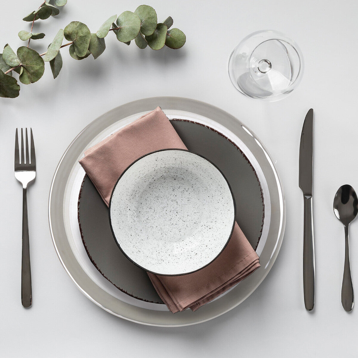 Embossed glass charger plate shown from above with spiral texture visible
