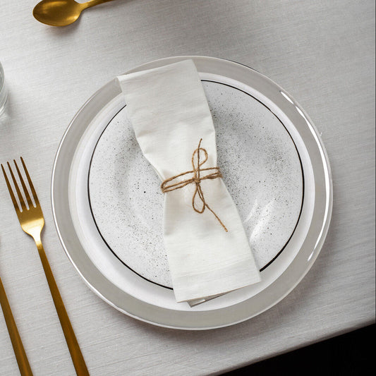 Set of four embossed glass charger plates with silver rim, 33cm