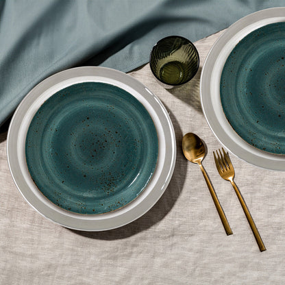 Glass charger plates styled with tableware for a formal dinner