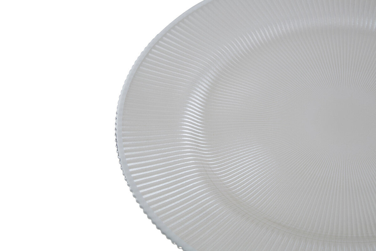 White glass charger plates styled with tableware for a formal dinner