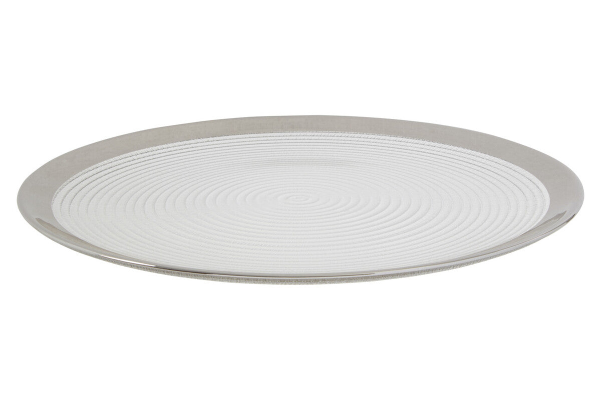 Glass coupe charger plate laid beneath a dinner plate in a place setting