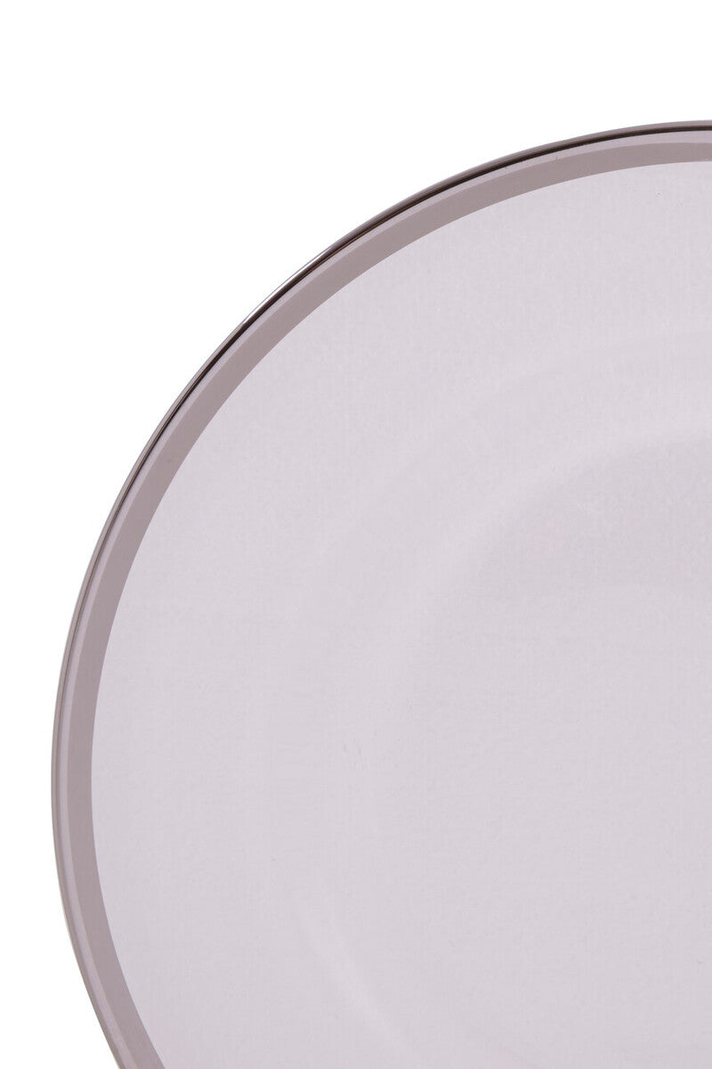 Glass charger plates styled with glassware and cutlery on a dining table