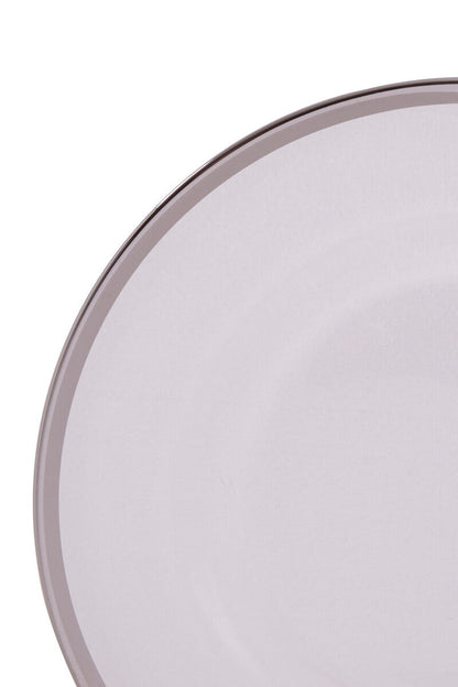 Glass charger plates styled with glassware and cutlery on a dining table