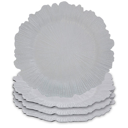 White charger plate laid beneath a dinner plate in a place setting