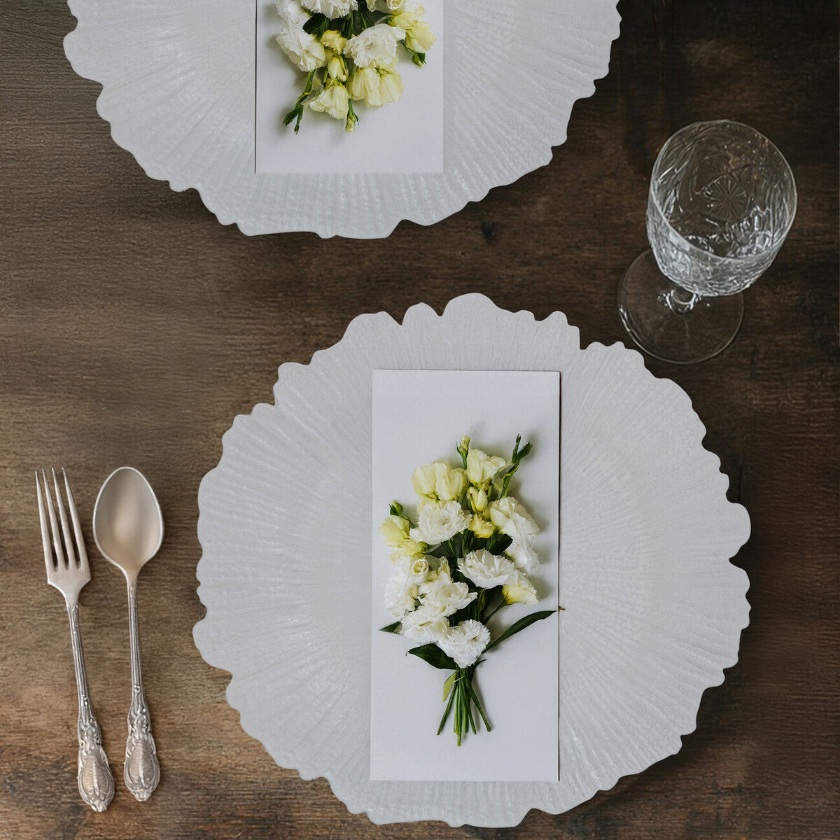 White reef charger plate styled on a dining table