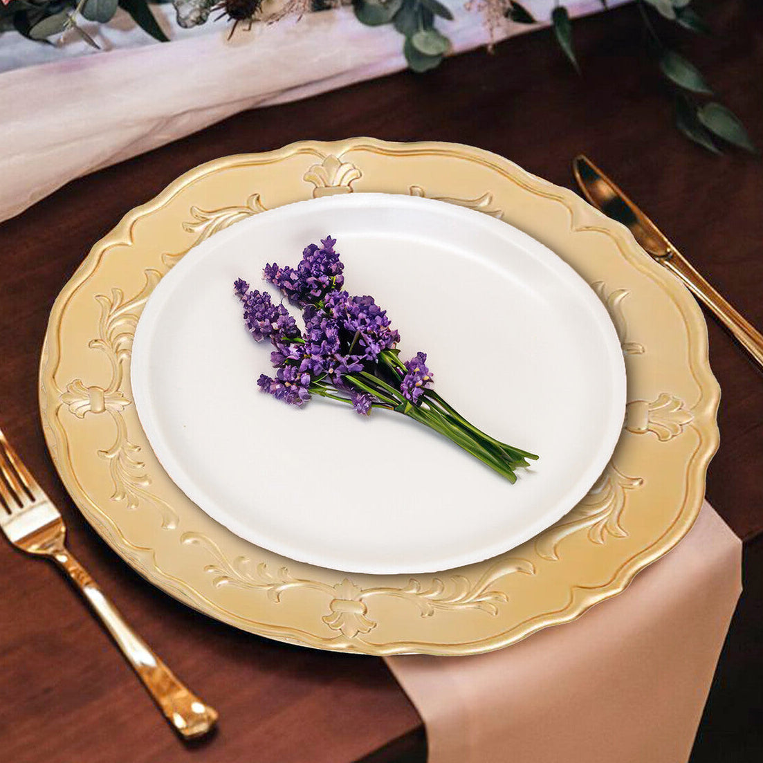 Gold baroque charger plate shown from above with scrollwork visible