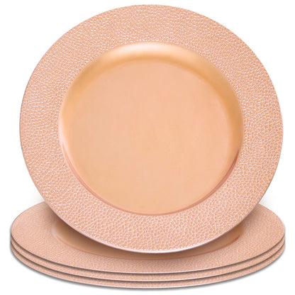 Rose gold charger plate laid beneath a dinner plate in a place setting