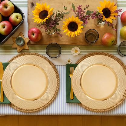 Four gold ribbed charger plates styled across a dining table