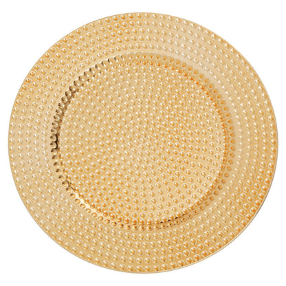Gold hammered charger plate laid beneath a dinner plate in a place setting