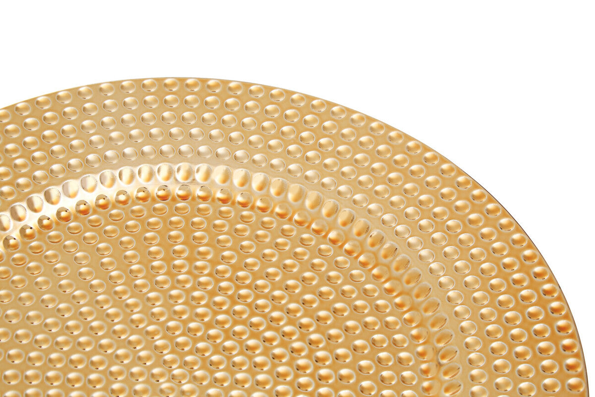 Gold hammered charger plates styled with tableware for a formal dinner