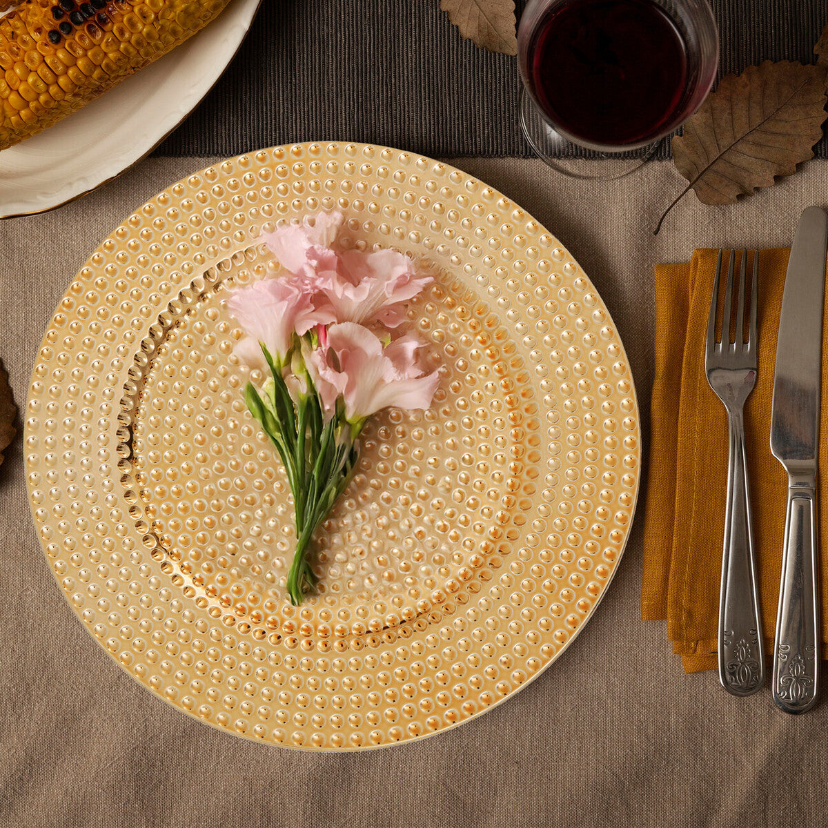 Gold hammered charger plates stacked showing the textured rim