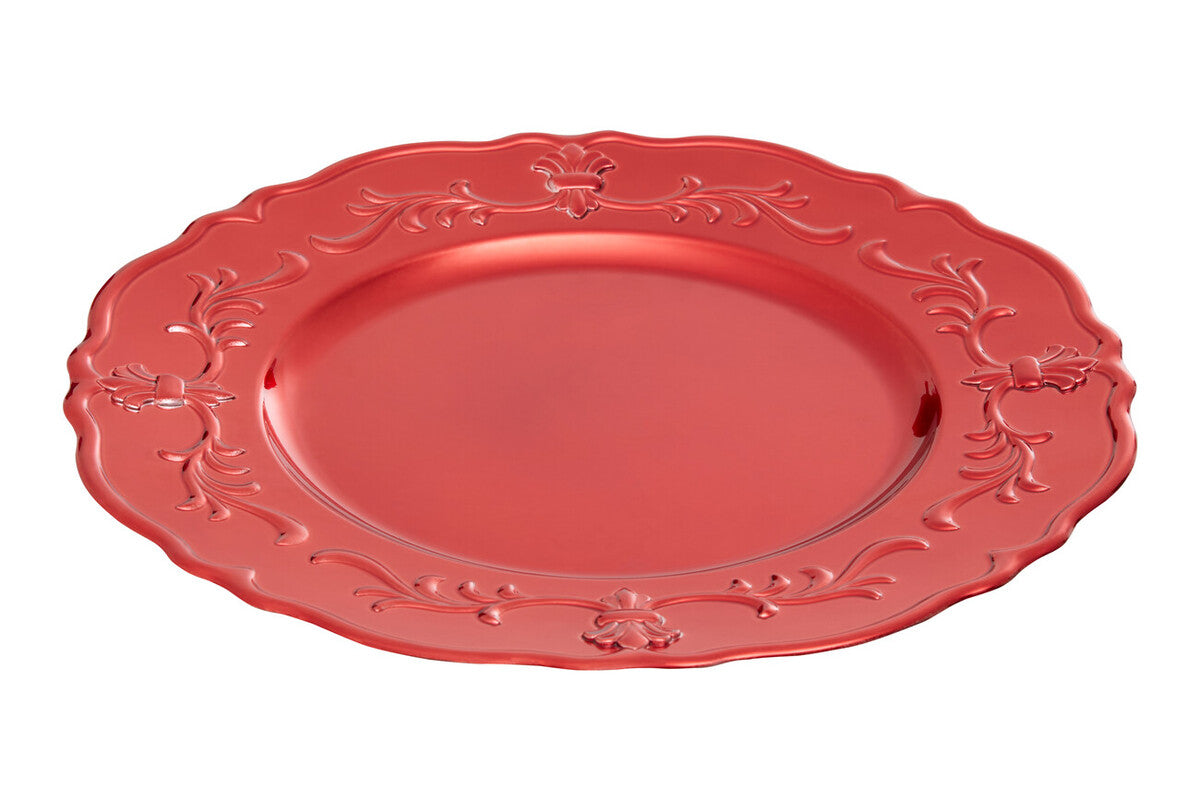 Red baroque charger plates styled with tableware for a festive dinner