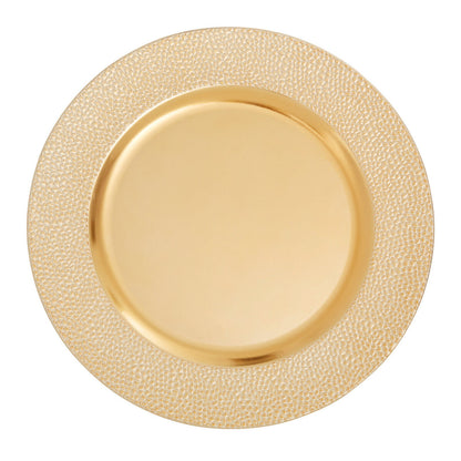 Gold charger plate laid beneath a dinner plate in a place setting