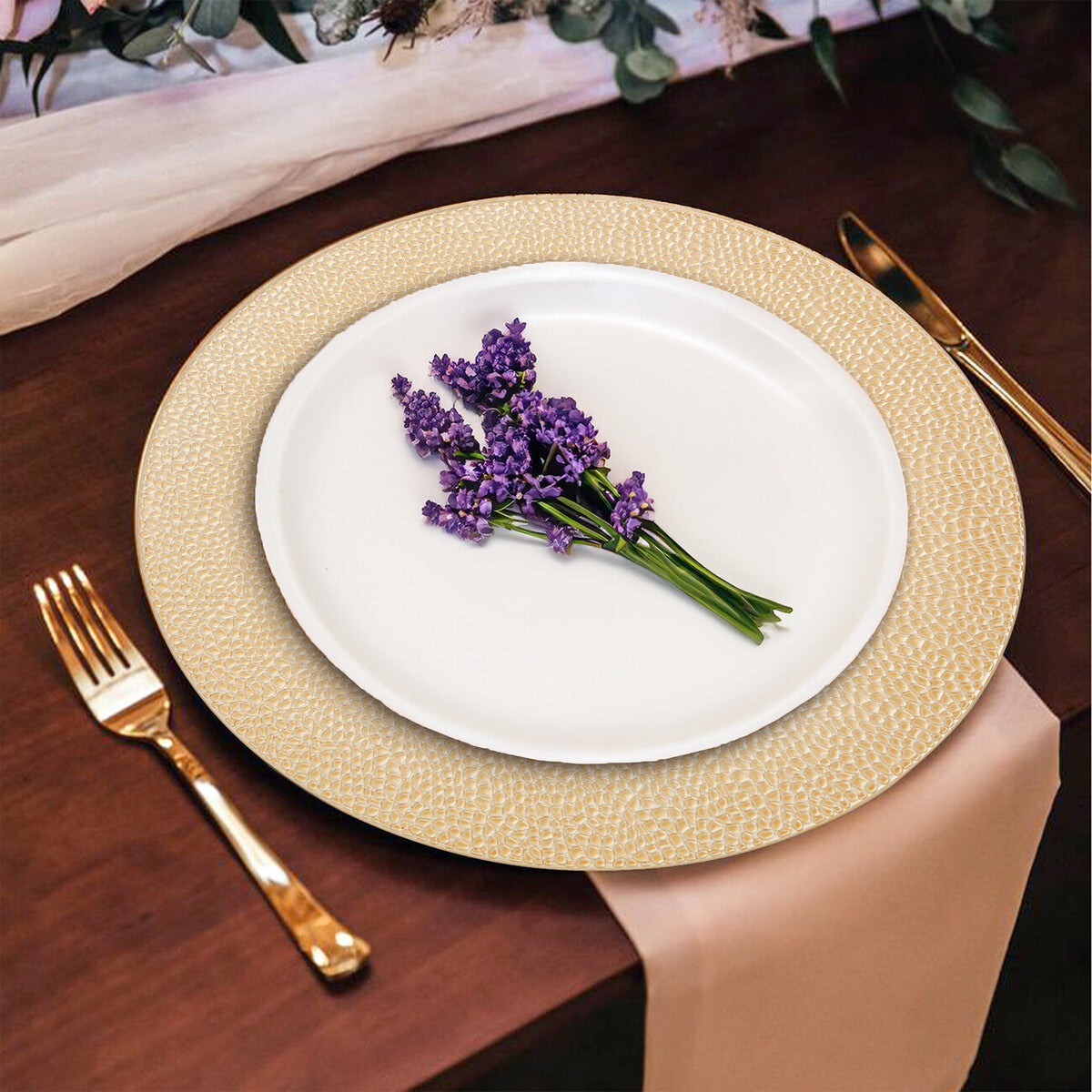 Gold charger plates stacked showing the pebble-effect texture