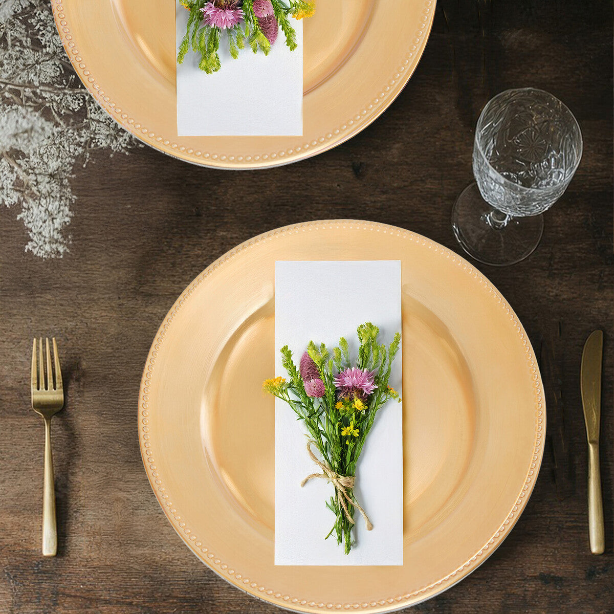 Gold charger plates stacked showing the dotted rim