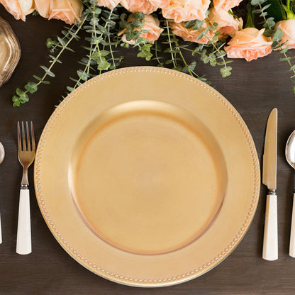 Four gold dotted charger plates styled across a dining table