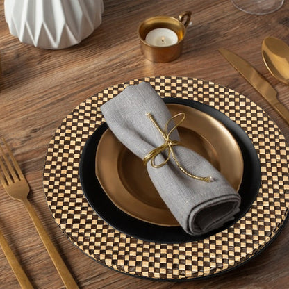 Black and natural charger plates stacked showing the woven texture