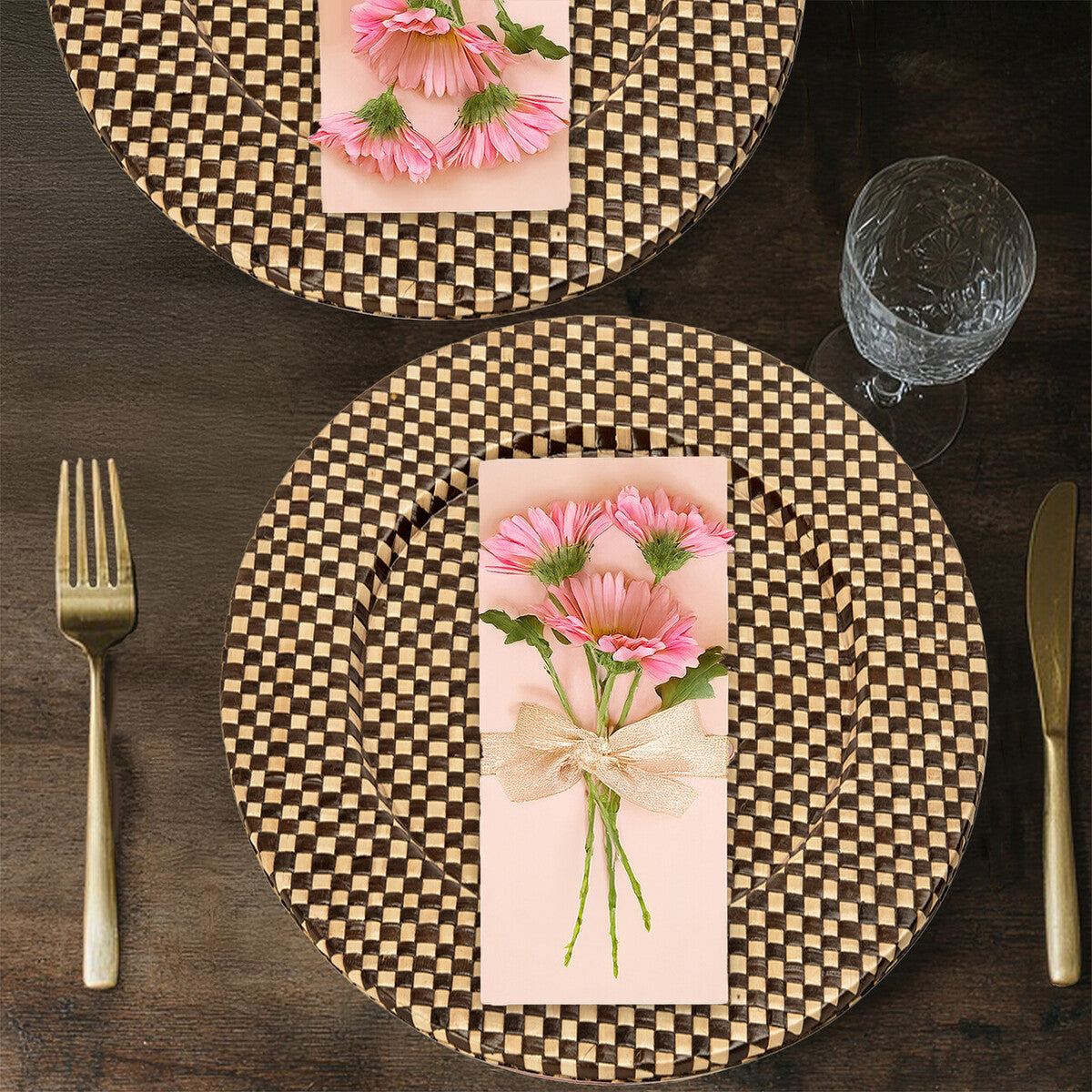 Four black and natural charger plates styled across a dining table