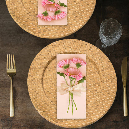 Four natural charger plates styled across a dining table