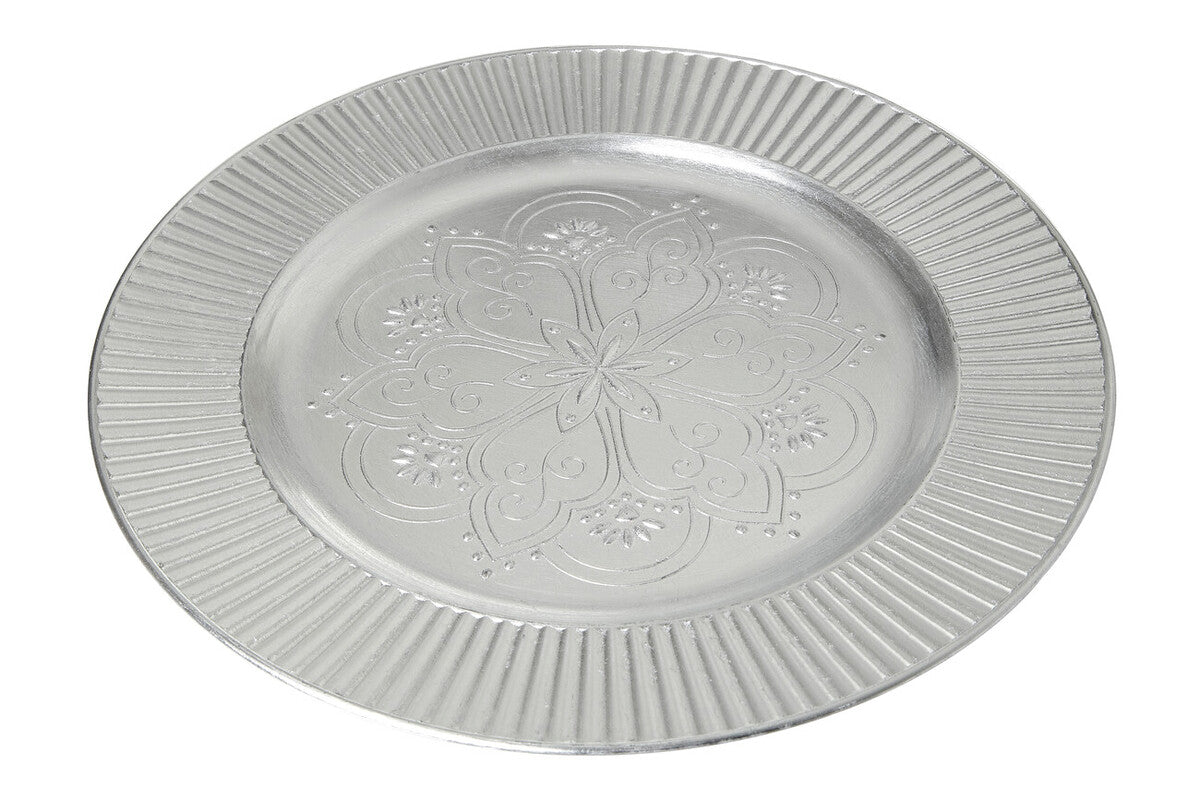 Four silver Redbud charger plates styled across a dining table