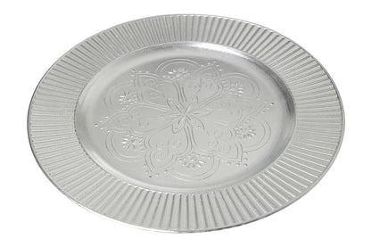 Four silver Redbud charger plates styled across a dining table