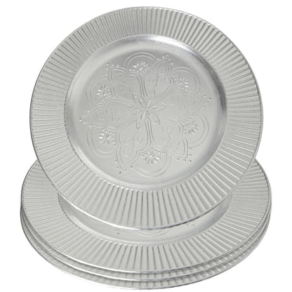 Close-up detail of the embossed redbud floral pattern on the silver charger plate