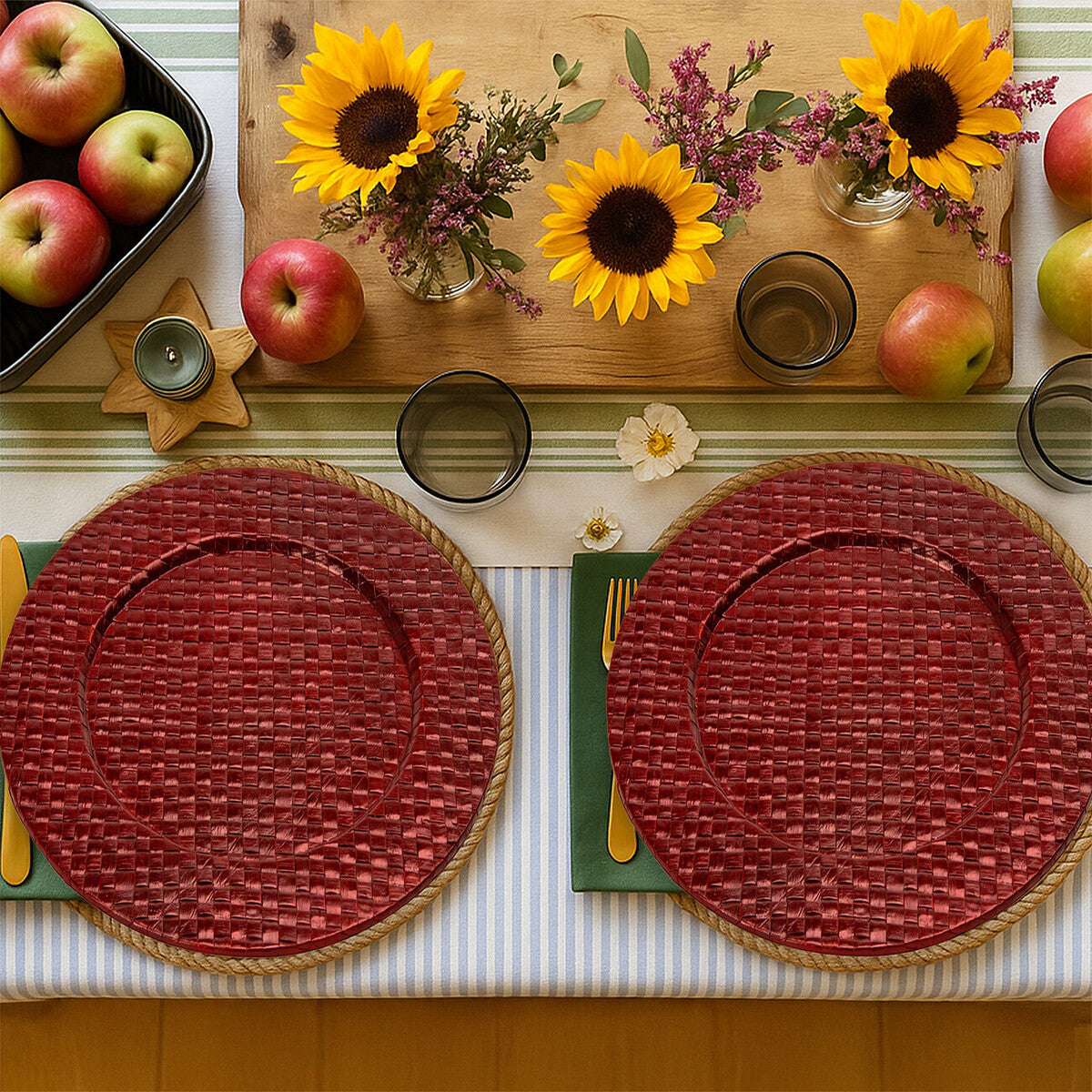 Four red charger plates styled across a dining table