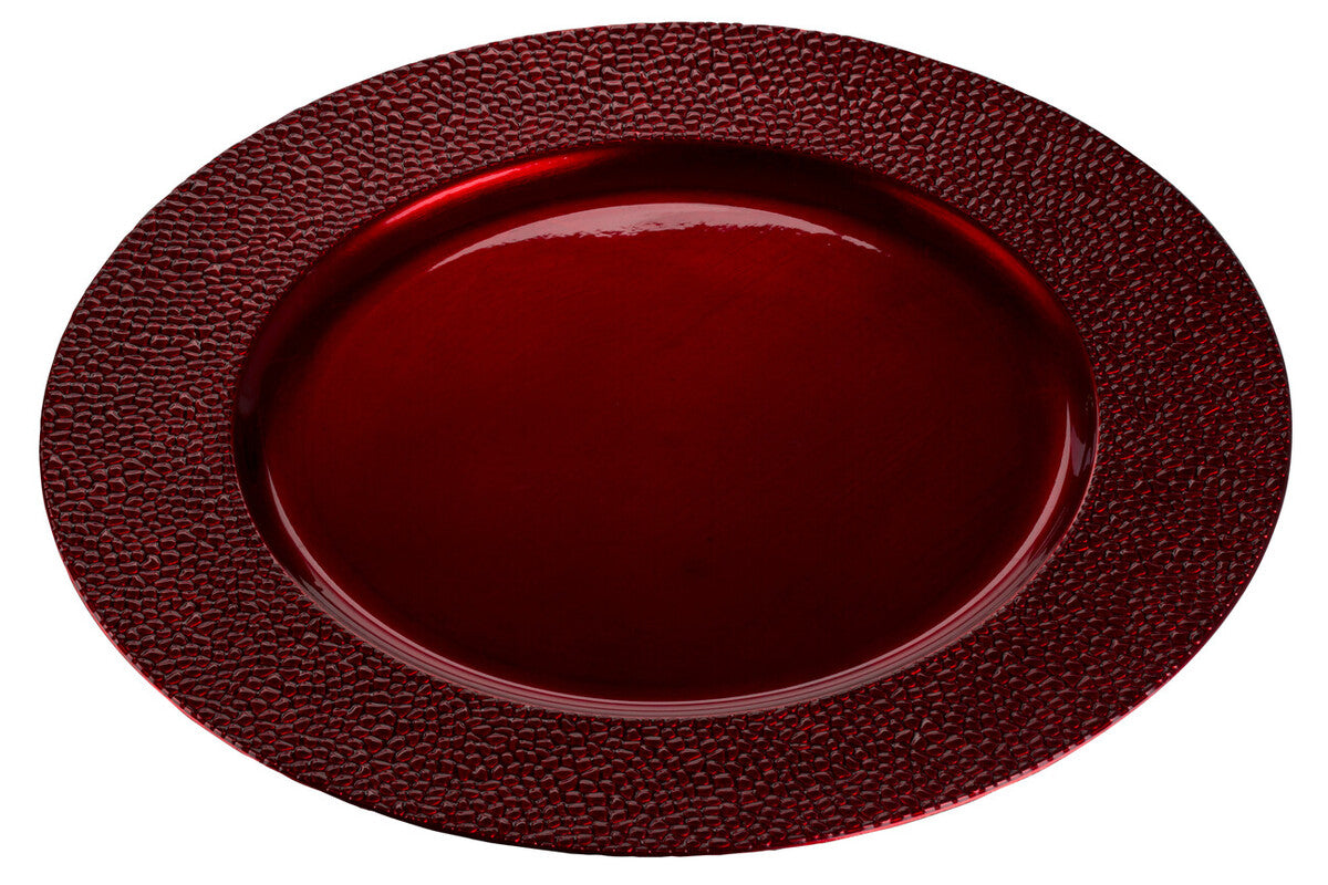 Red charger plate laid beneath a dinner plate in a place setting
