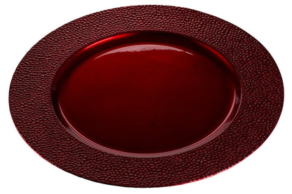 Red charger plate laid beneath a dinner plate in a place setting