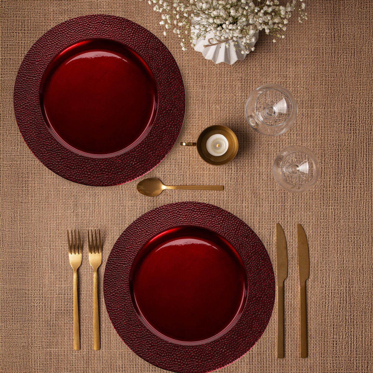 Red charger plates stacked showing the pebble-effect texture