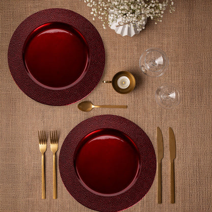 Red charger plates stacked showing the pebble-effect texture