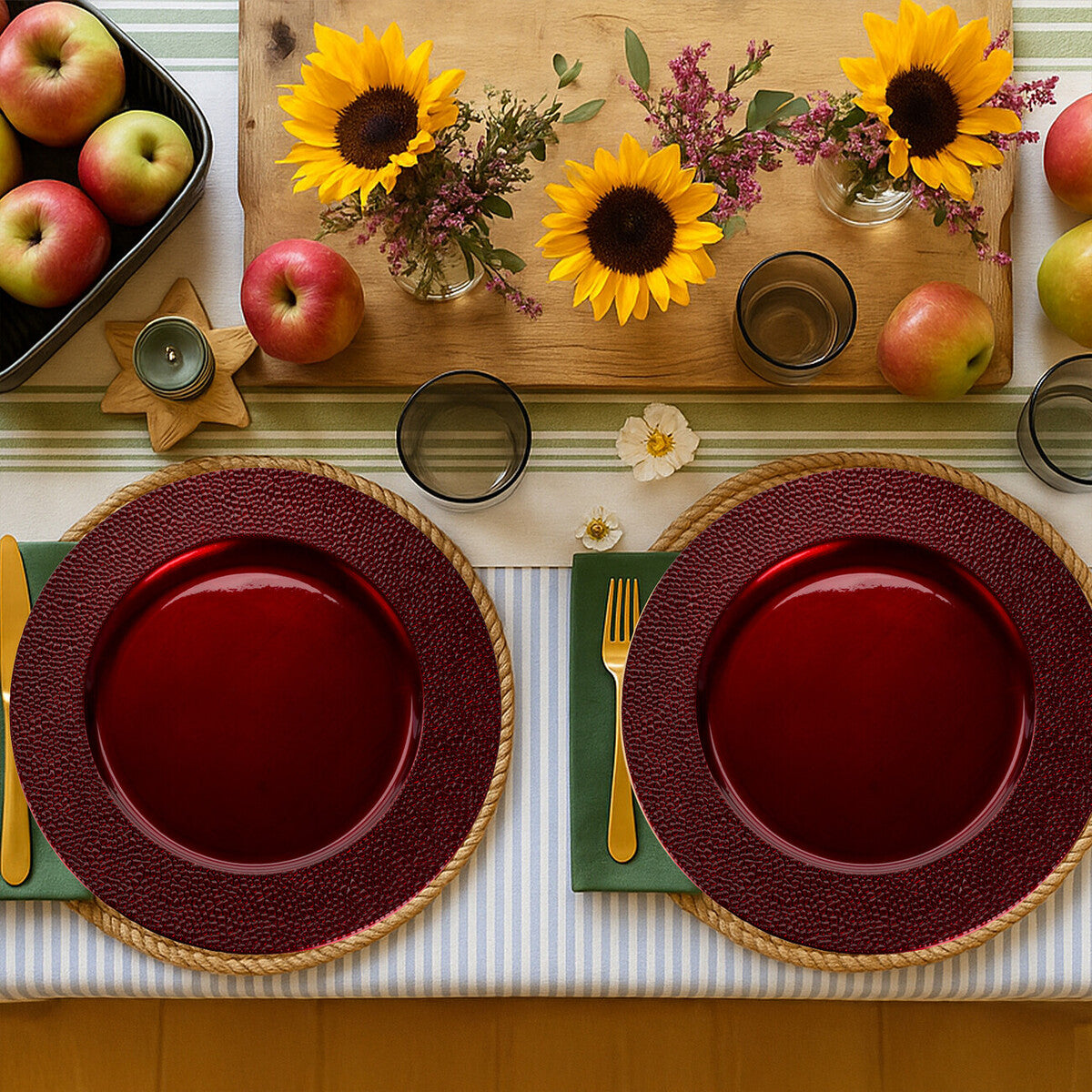 Four red charger plates styled across a dining table