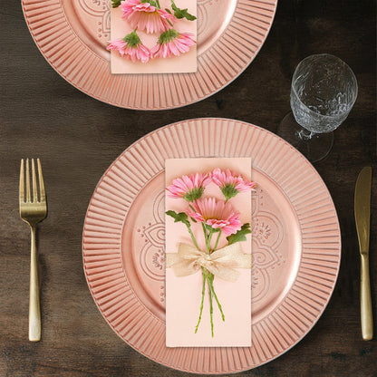 Rose gold charger plate shown from above with etched pattern visible