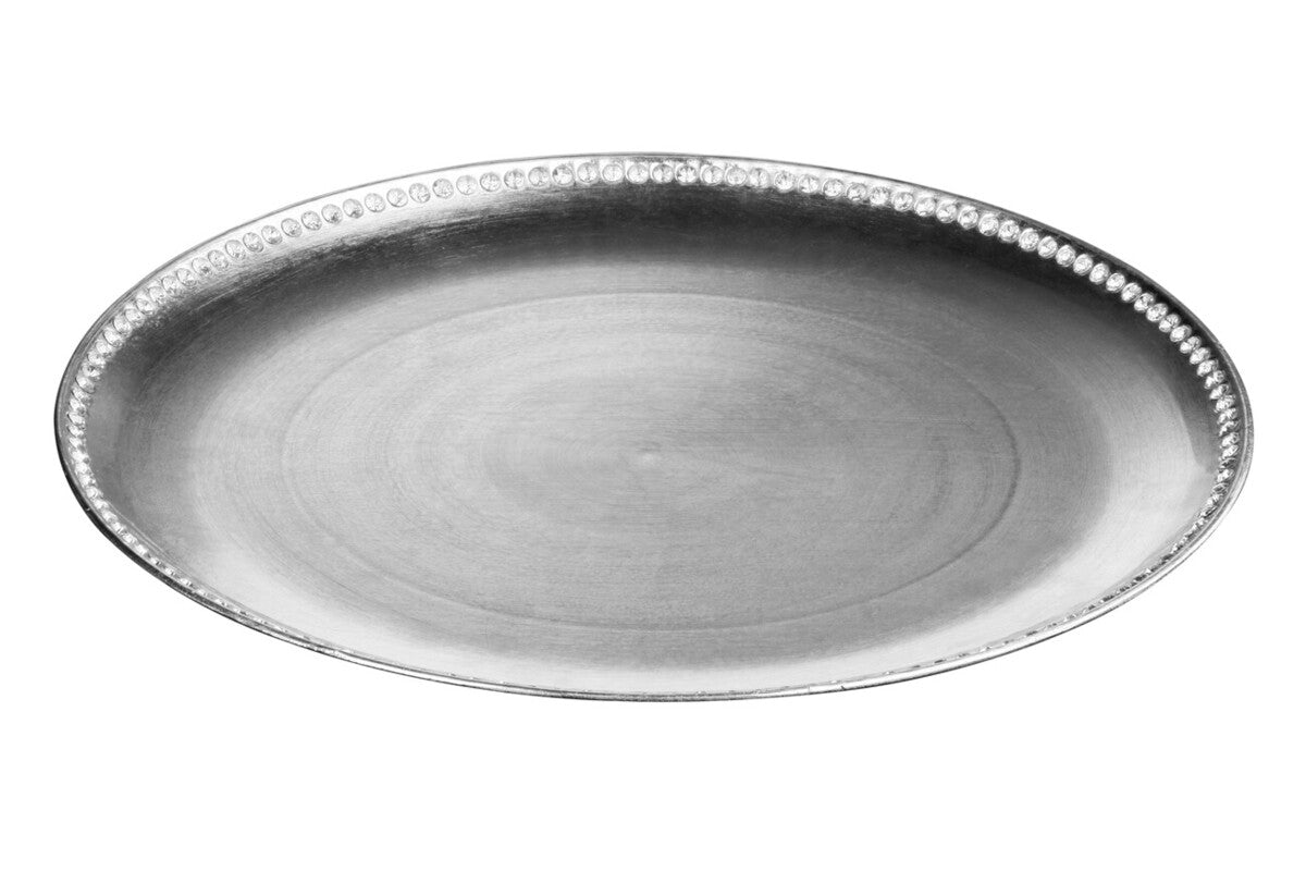 Silver charger plate laid beneath a dinner plate in a place setting