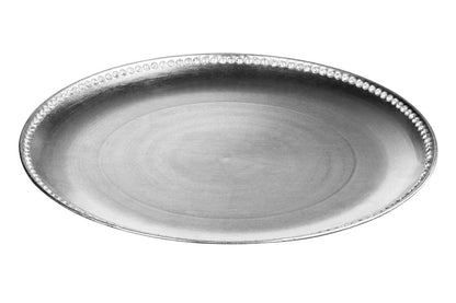 Silver charger plate laid beneath a dinner plate in a place setting