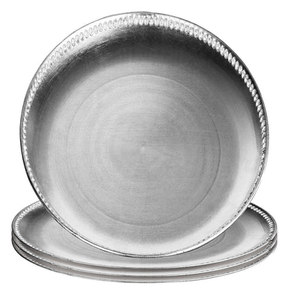 Silver charger plates styled with tableware for a formal dinner
