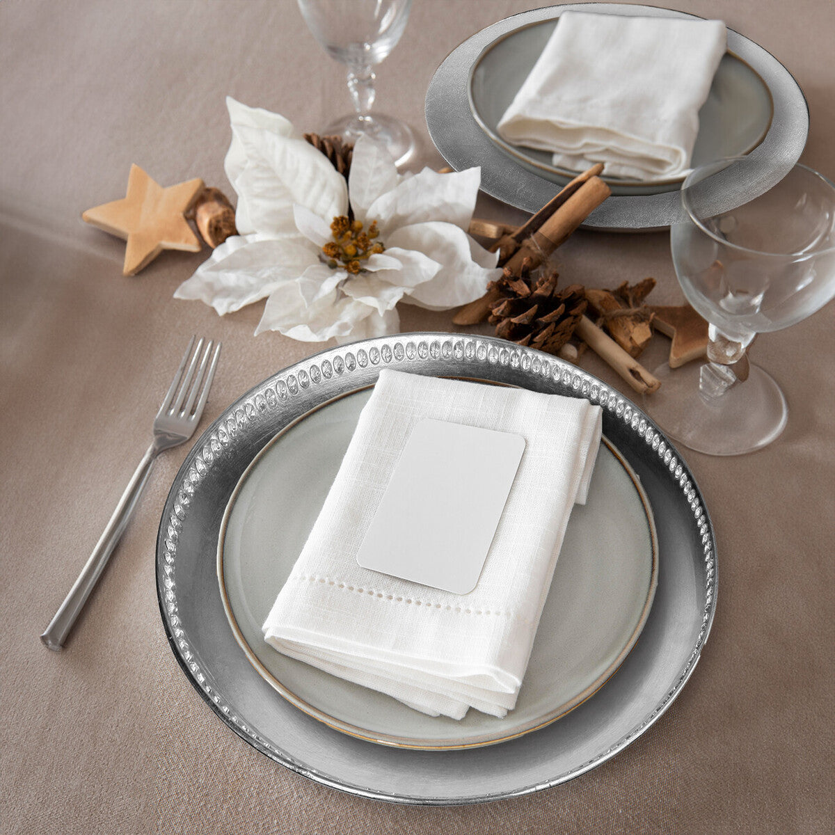 Silver decorative charger plate shown from above