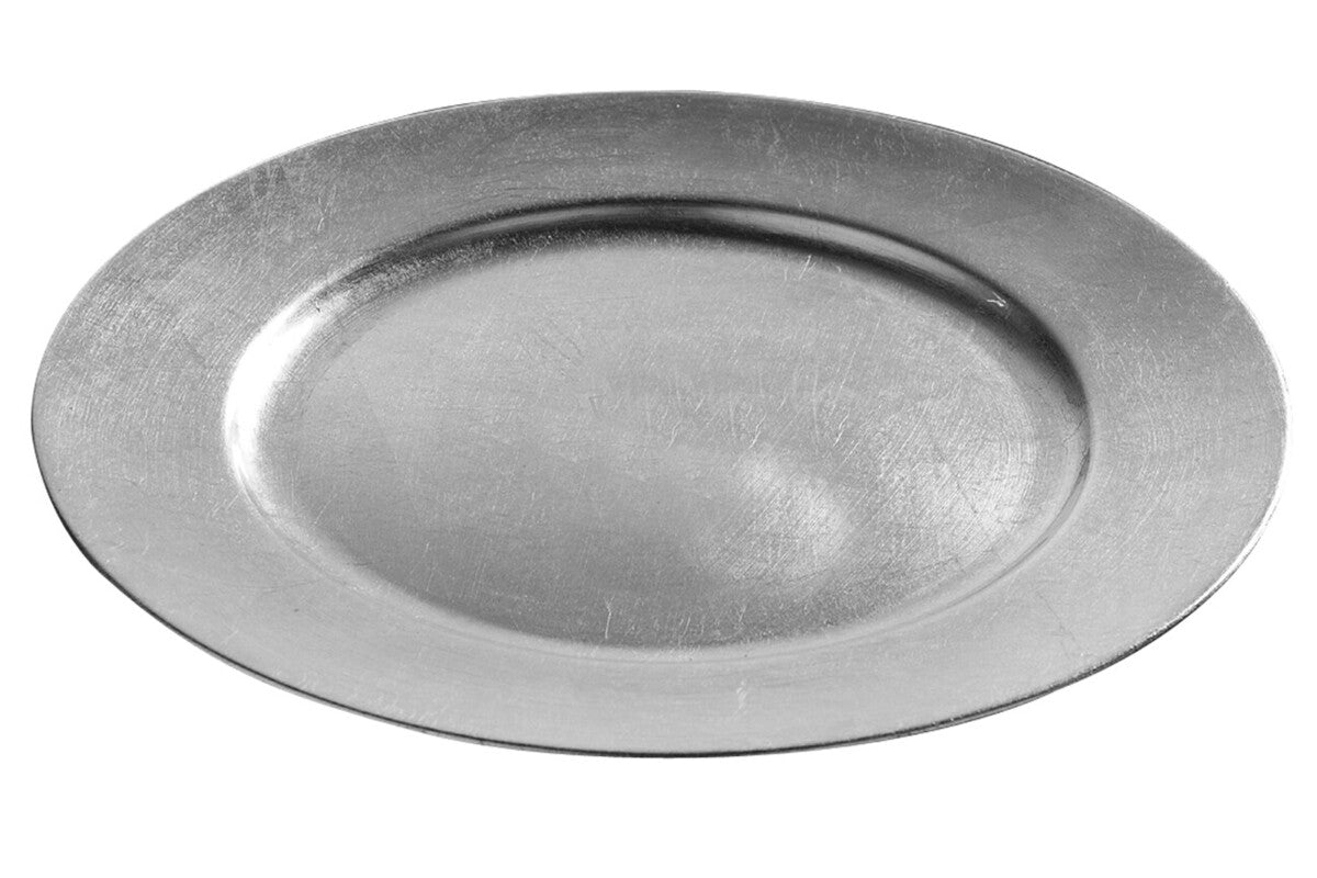 Silver charger plate laid beneath a dinner plate in a place setting