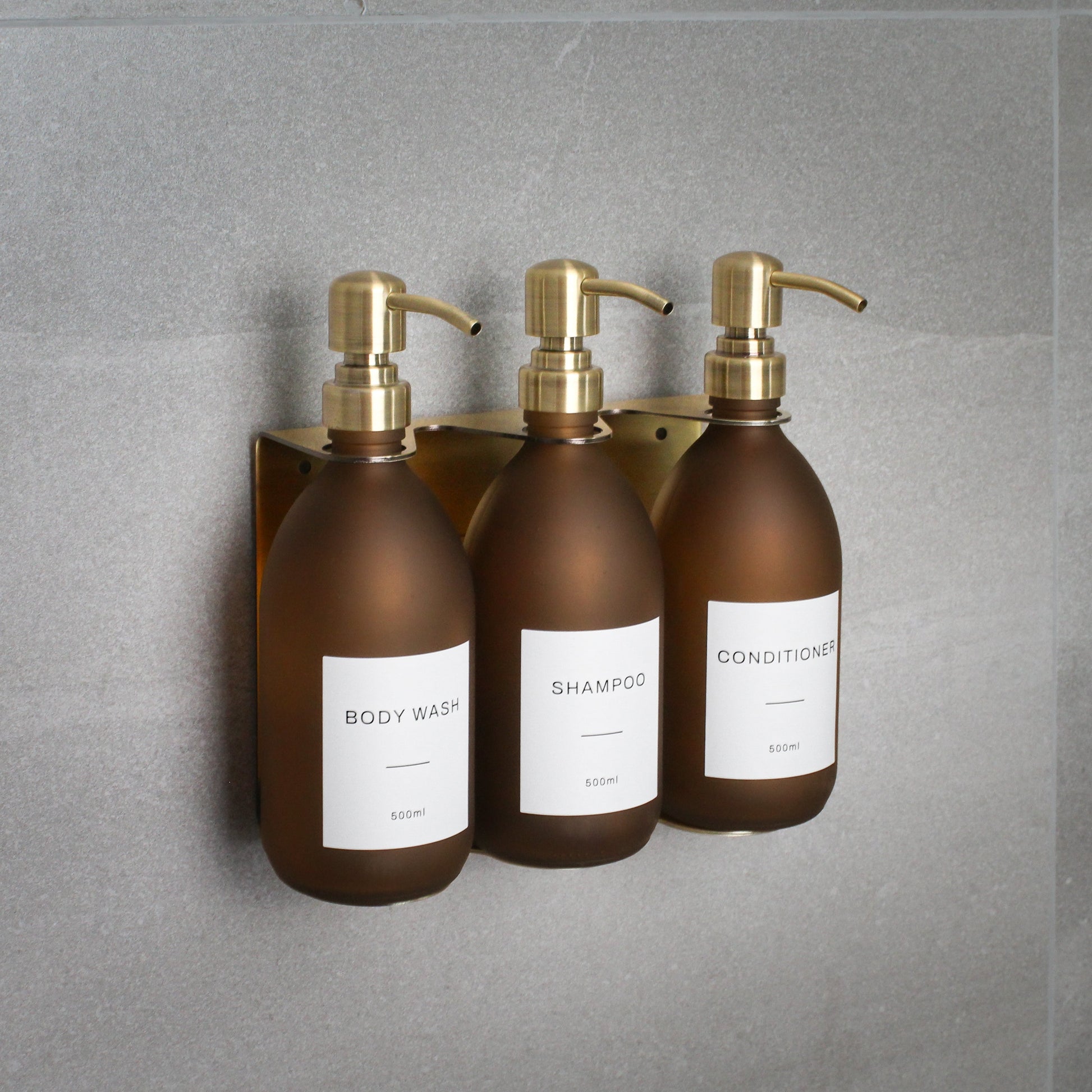 Namie Gold Wall Mounted Dispenser Bracket Set with Frosted Amber Glass Bottles