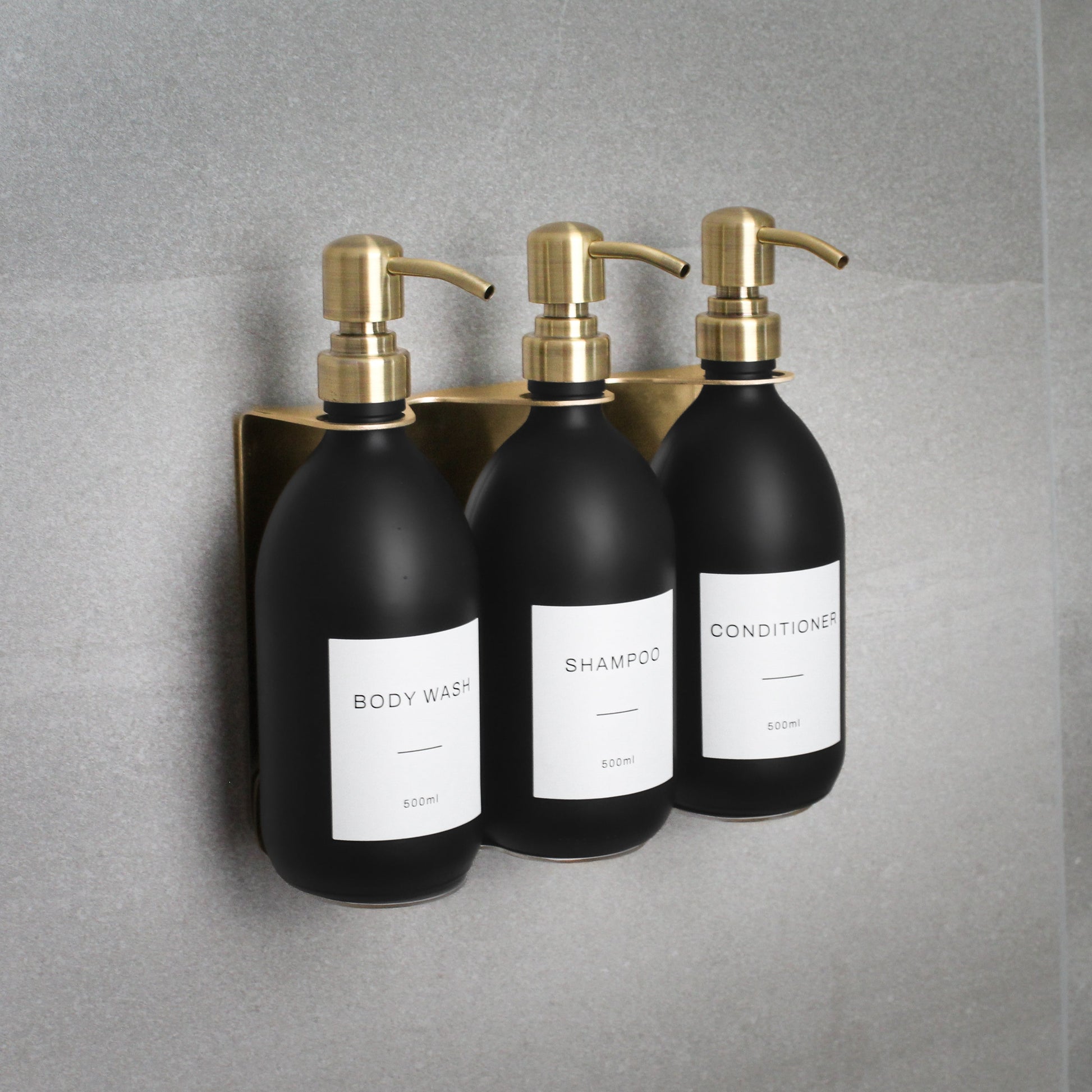 Namie Gold Wall Mounted Dispenser Bracket Set with Matte Black Bottles